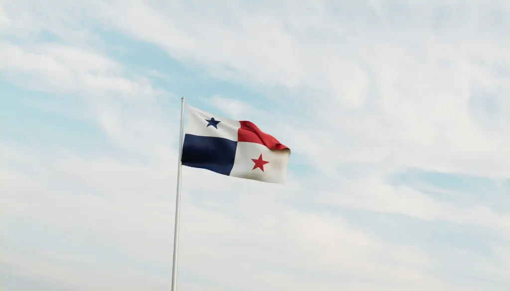 Panamanian flag waving against a bright sky